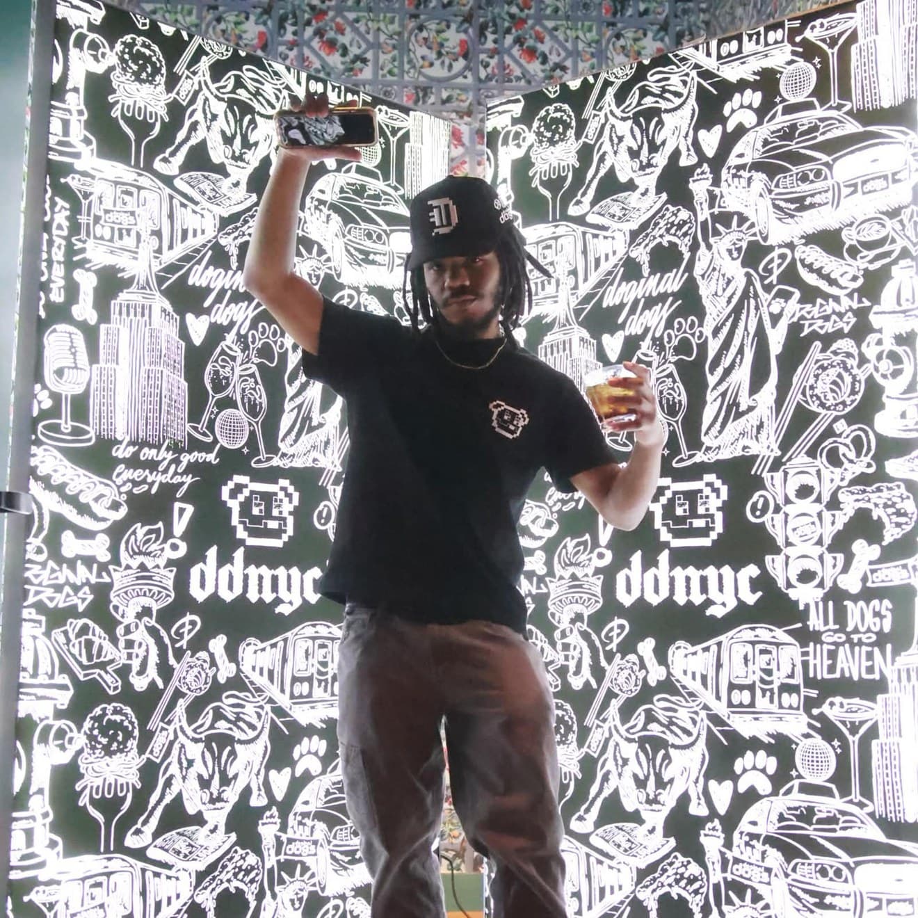 Corn (@CornKry) at DDNYC in front of a Doginal Dogs mural